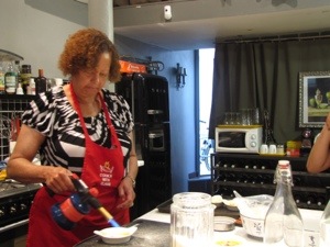 Carmelizing the sugar on the creme brulee.